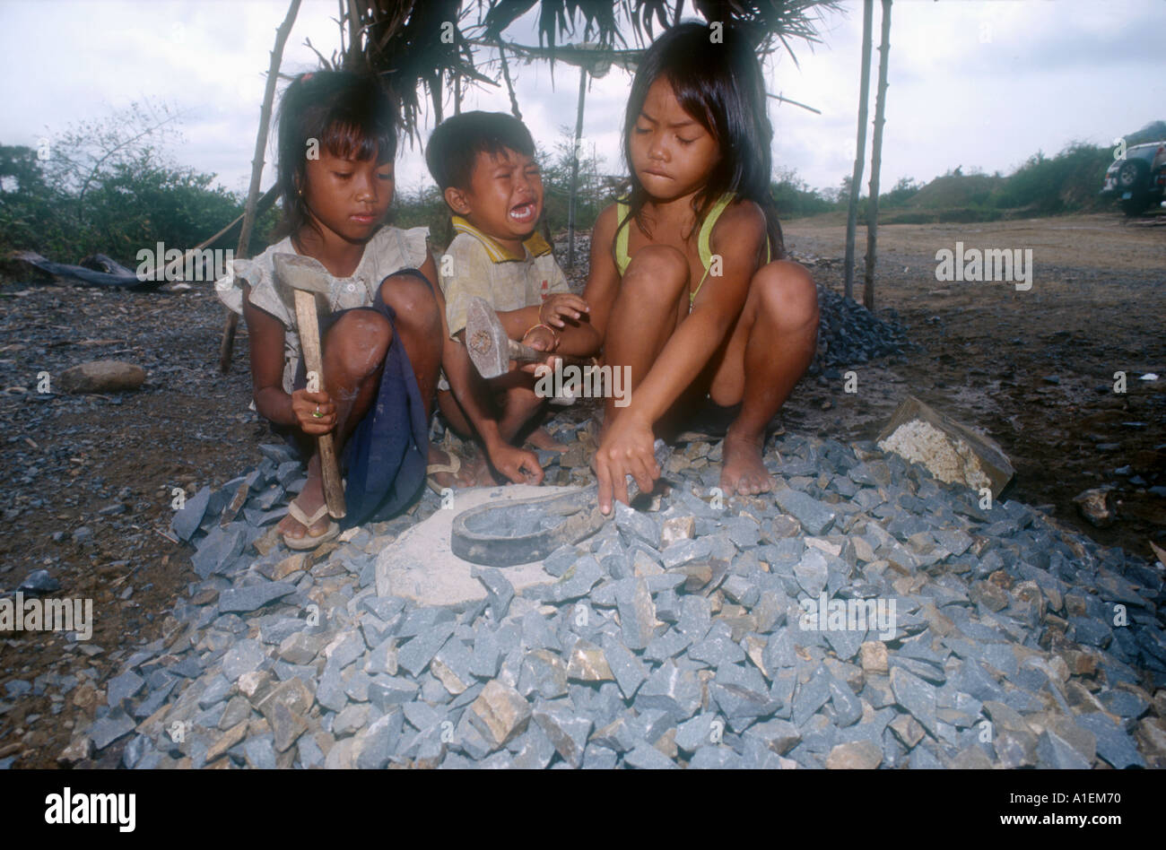 Child labourers work in a quarry breaking stones to build roads. Takeo ...