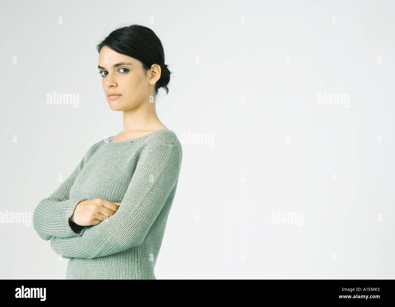 Woman standing sideways arms folded hi-res stock photography and images ...