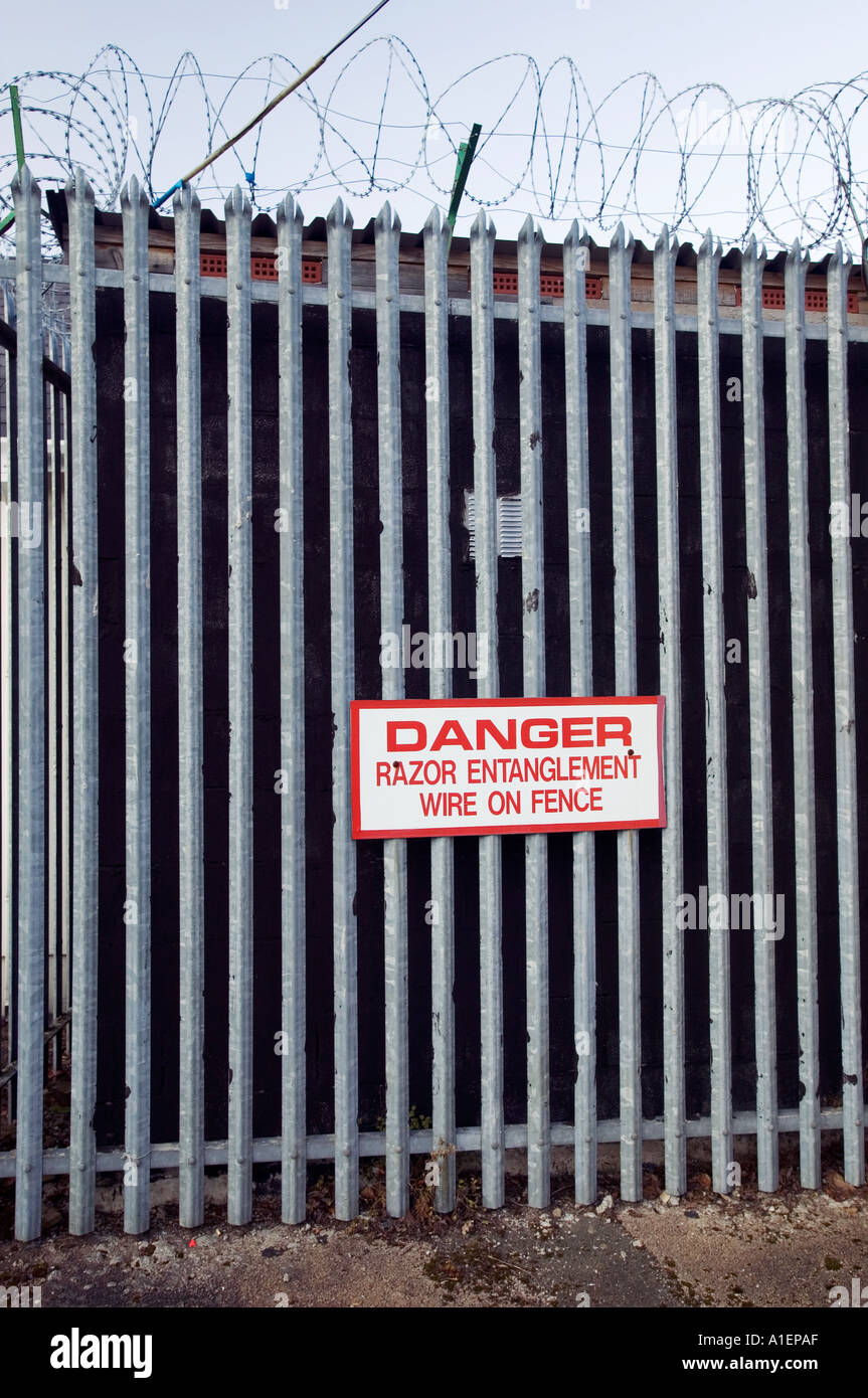 Fence protected with razor wire with warning sign Llanfoist Abergavenny South Wales UK Stock Photo