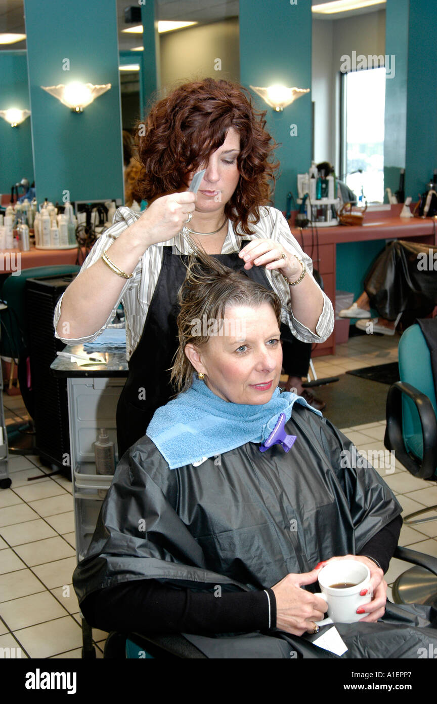 Woman has hair cut shampoo color and permanent done by a beautician