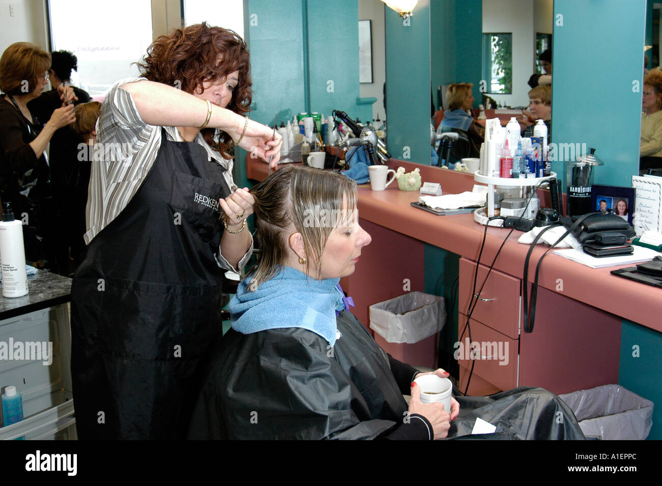 Woman has hair cut shampoo color and permanent done by a beautician