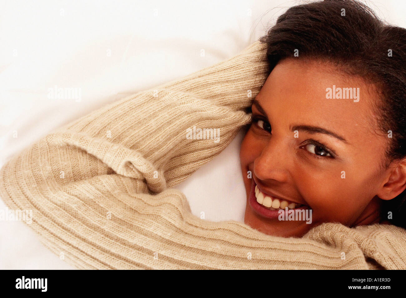 Smiling young woman lying down Stock Photo