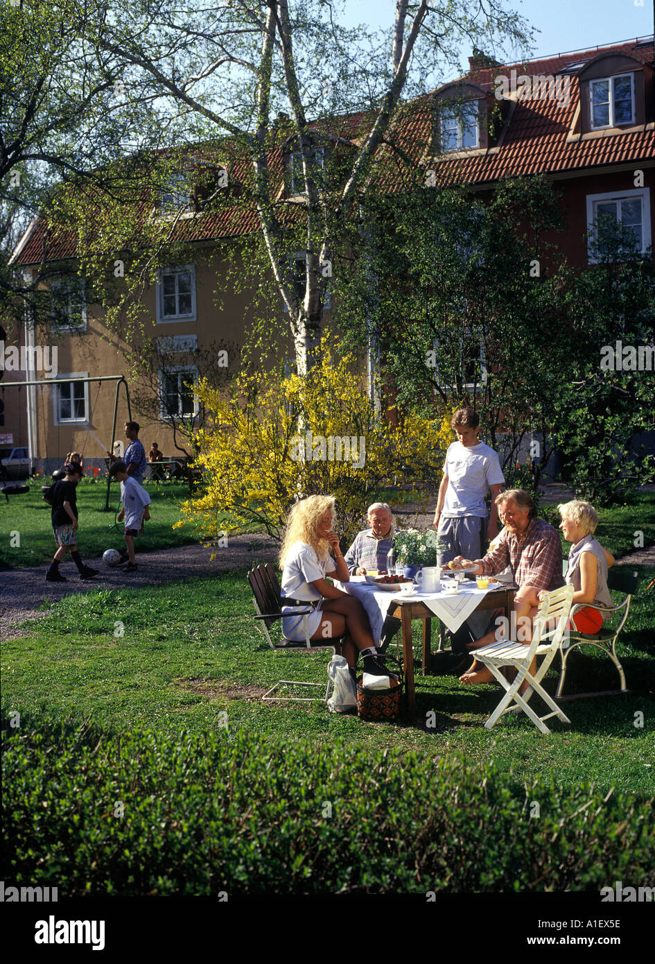 Family having coffee and afternoon tea in their backyard Stock Photo