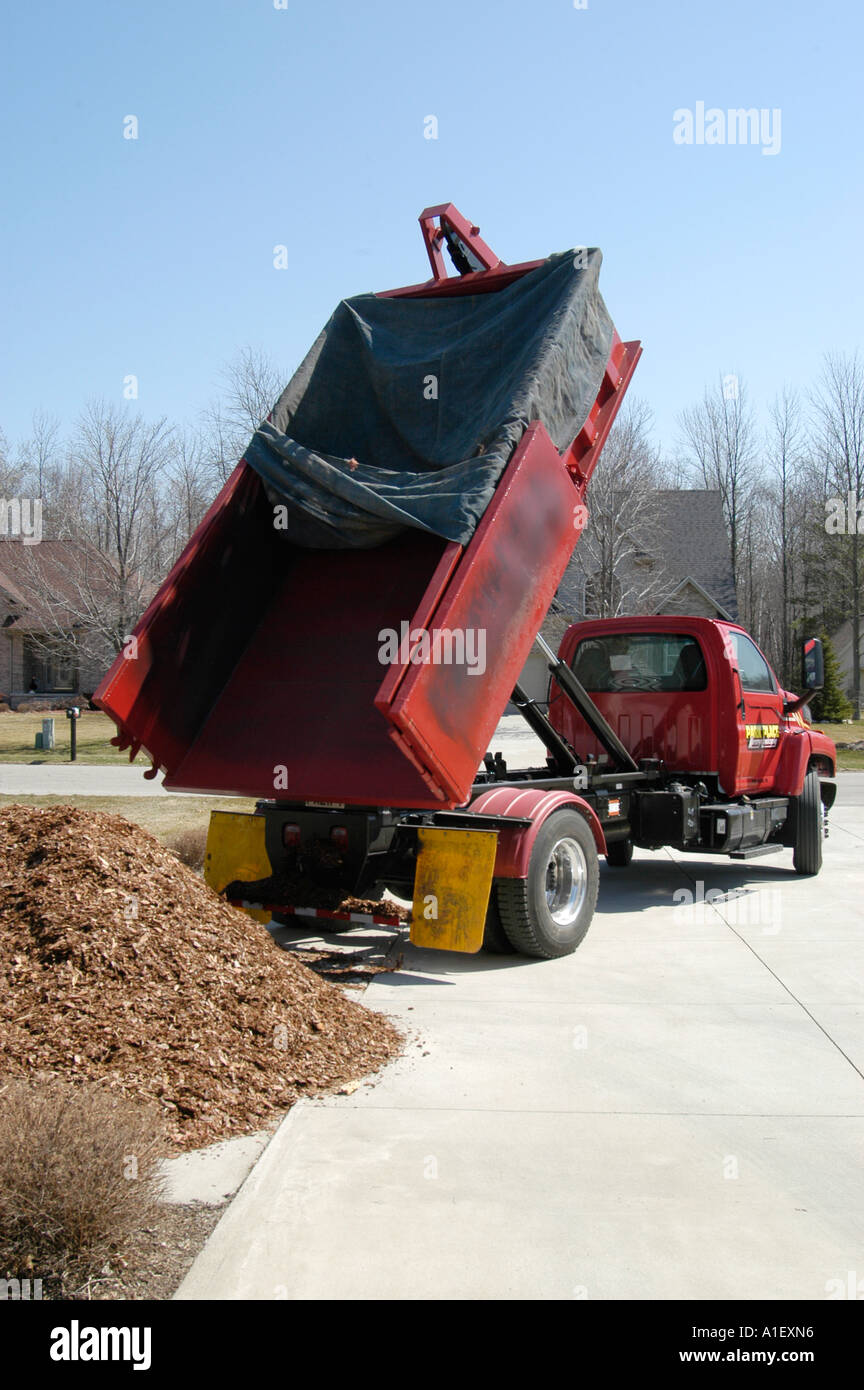 Dump truck drops load of mulch for use in landscaping and flower beds