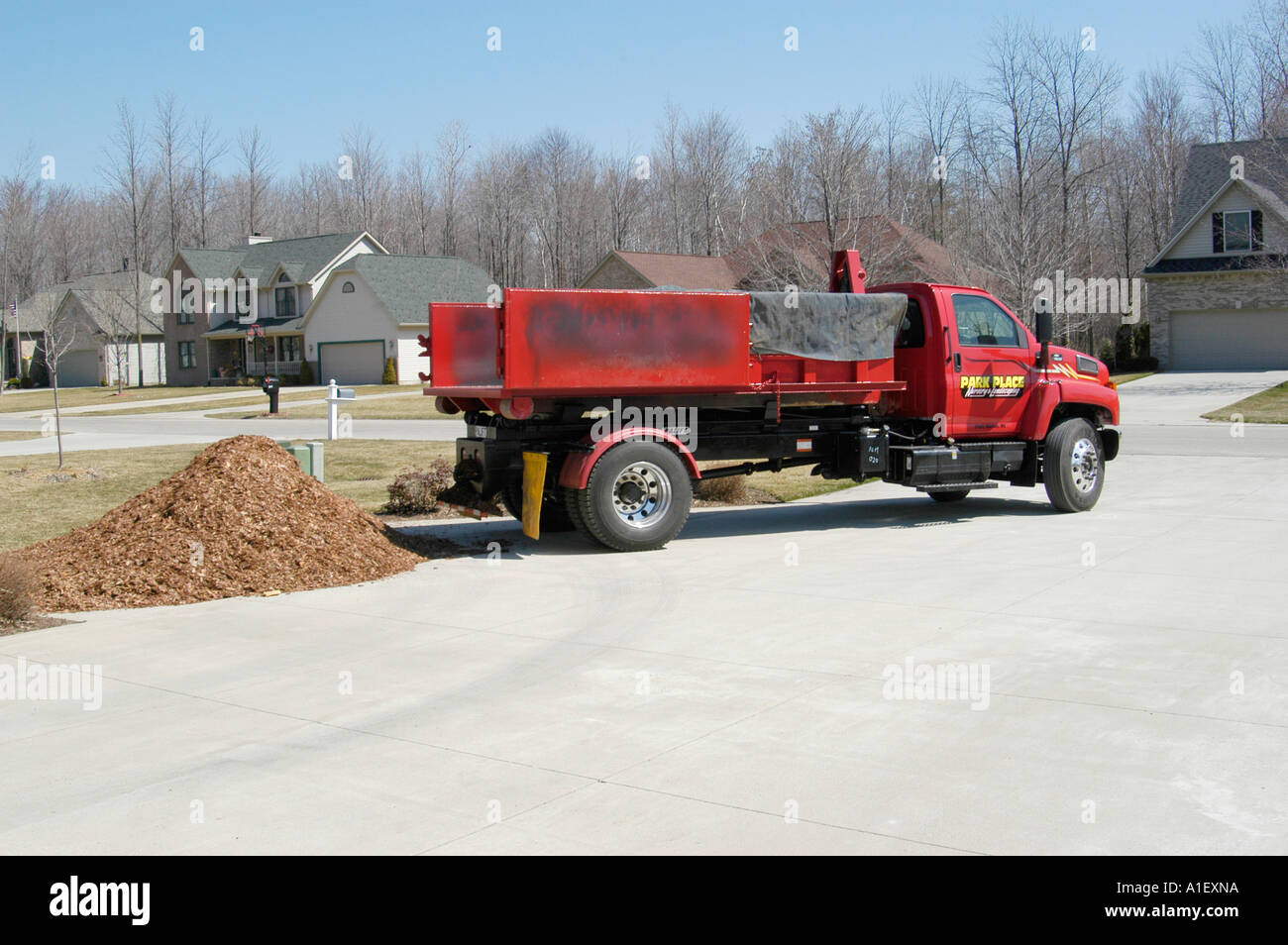 Dump truck drops load of mulch for use in landscaping and flower beds