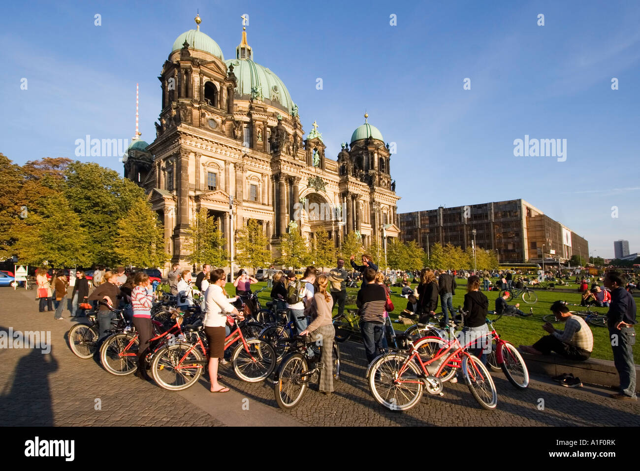 Berlin dome tour guide with tourists on bicylces Stock Photo