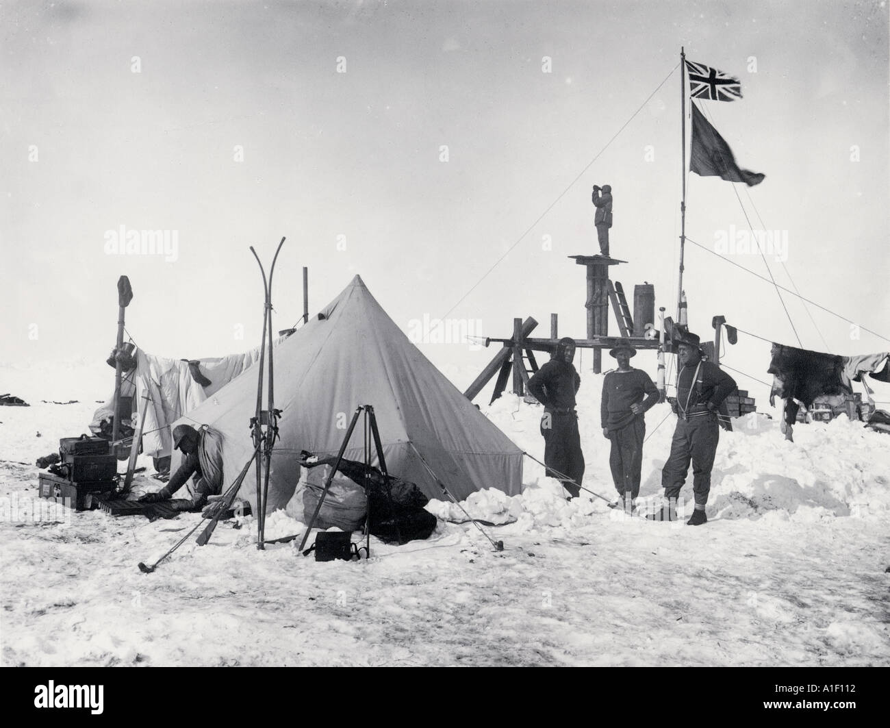 Ernest Shackleton and Frank Wild at Ocean Camp with the Lookout flying the King s flag and the ship s burgee  Stock Photo