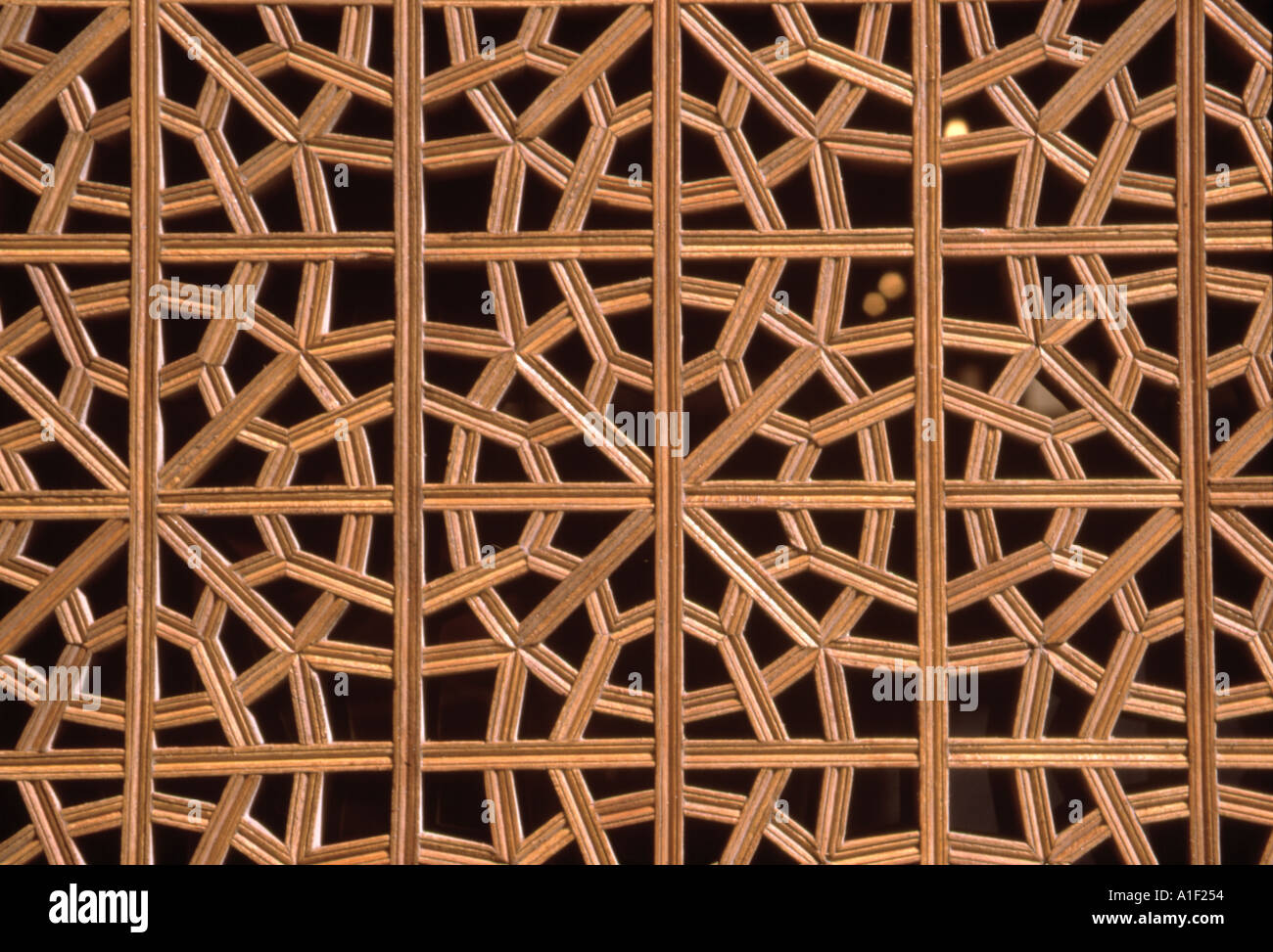 Intricate lattice work with geometric design on wood Isfahan Iran Stock