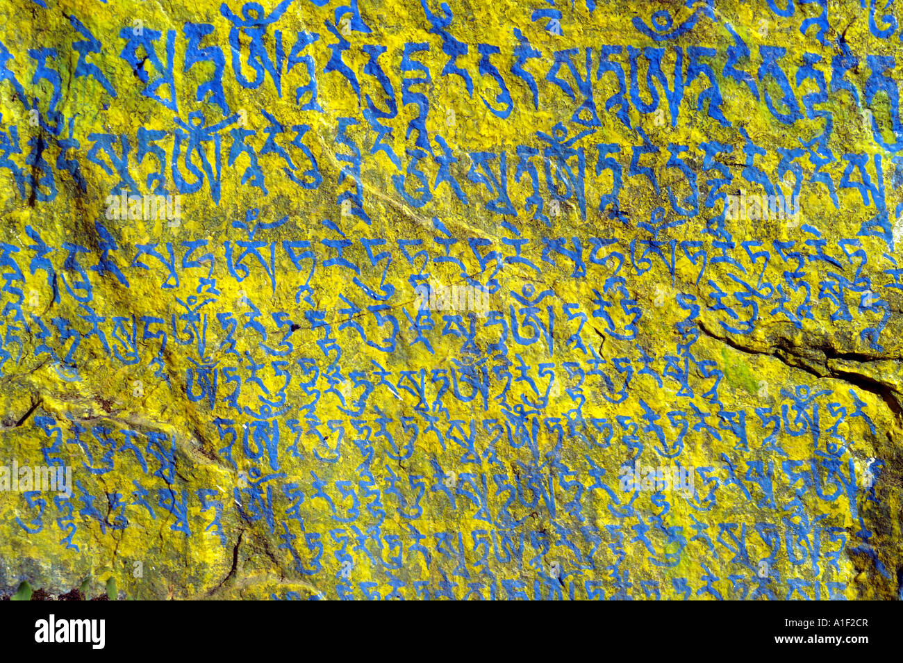 Om mani padme hum blue sign on Mani stone, McLeod Ganj, India Stock Photo