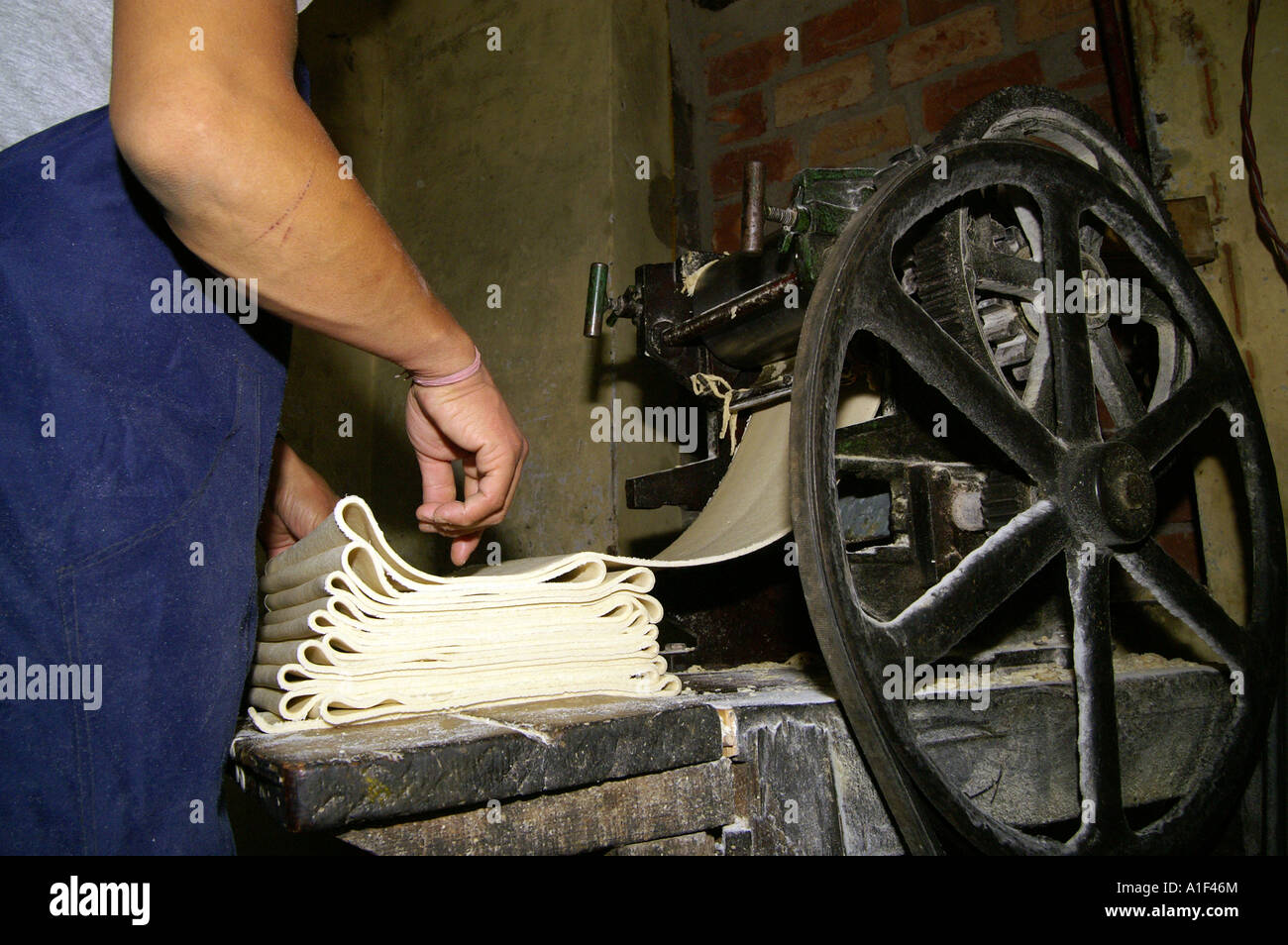 Tibetan buddhist monks machine cutting ritual cakes dew, Namgyal