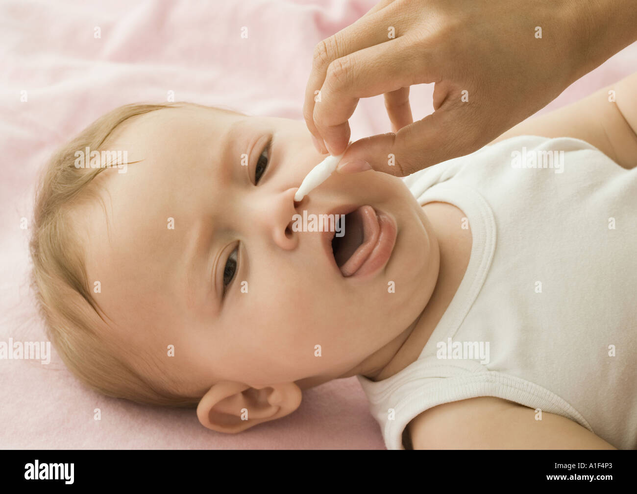 Baby having nose cleaned Stock Photo Alamy
