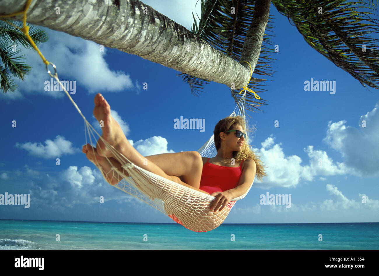 Woman lying in a hammock Stock Photo - Alamy