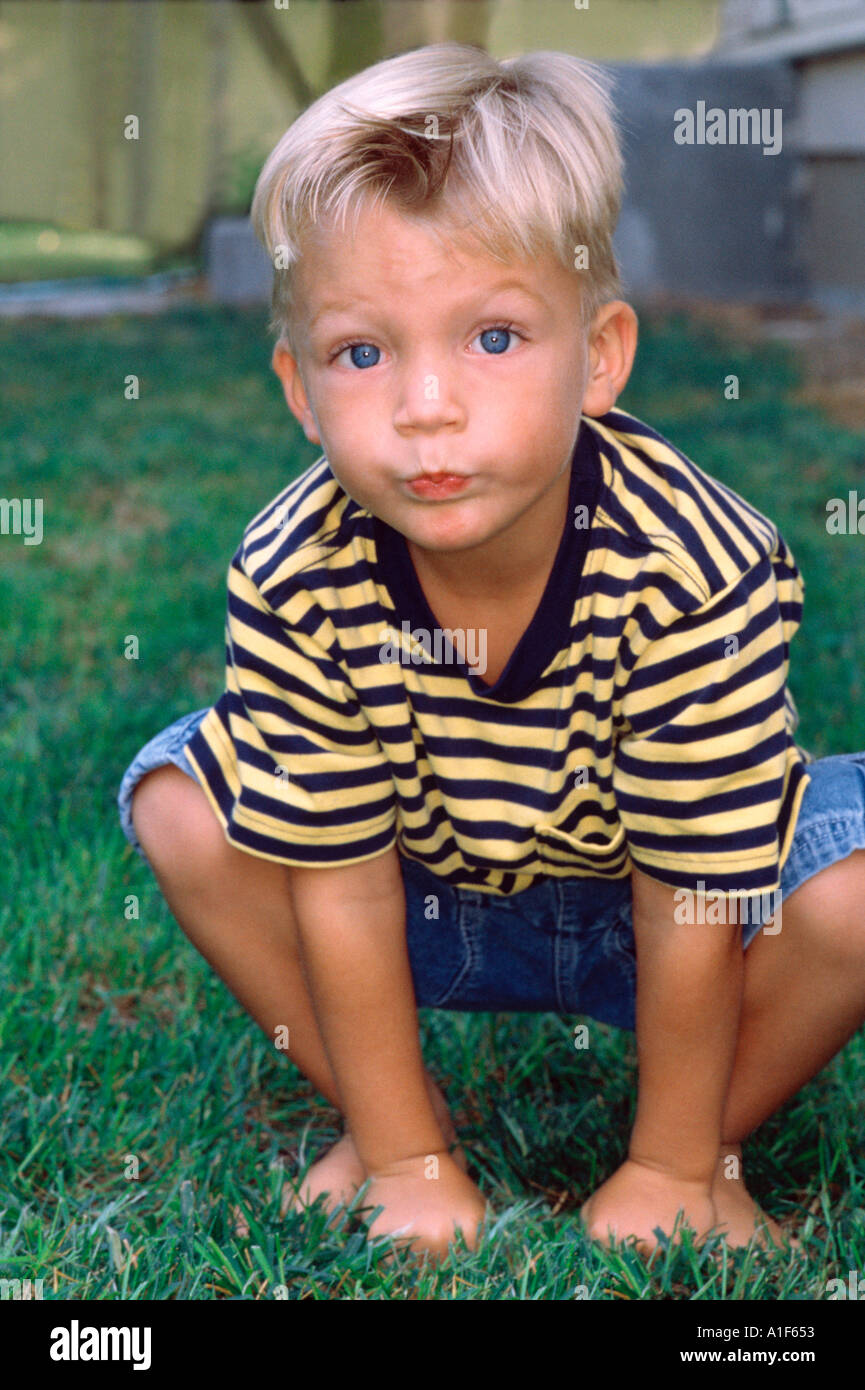 Young boy playing in back yard Stock Photo