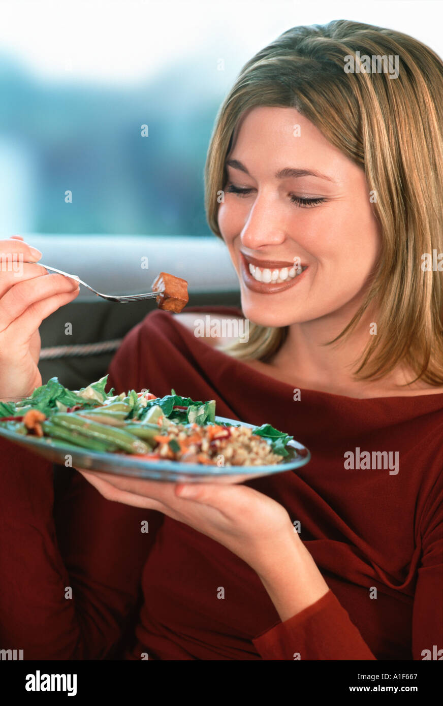 Happy woman eating healthy salad Stock Photo