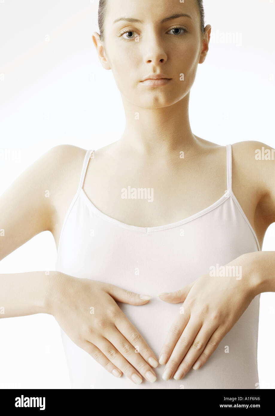 Woman holding hands over stomach Stock Photo