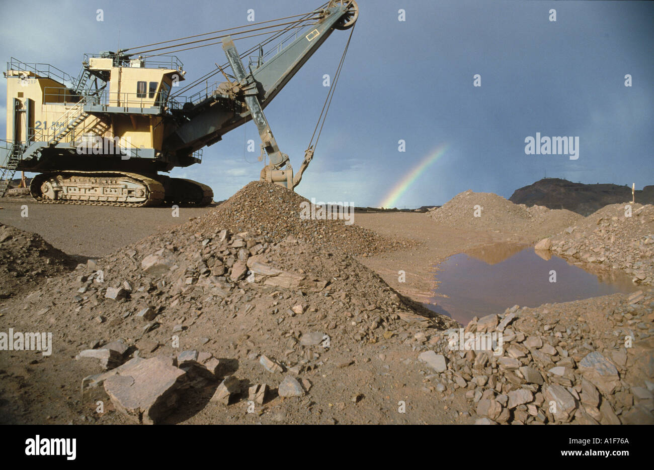 Gigantic shovel in open cut mine Australia, rainbow at back Stock Photo