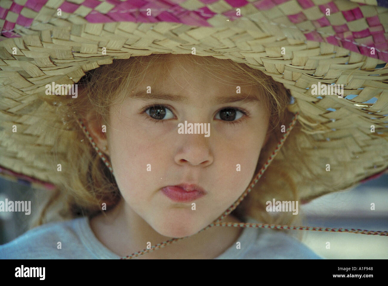 little girl wearing a large straw hat Stock Photo - Alamy