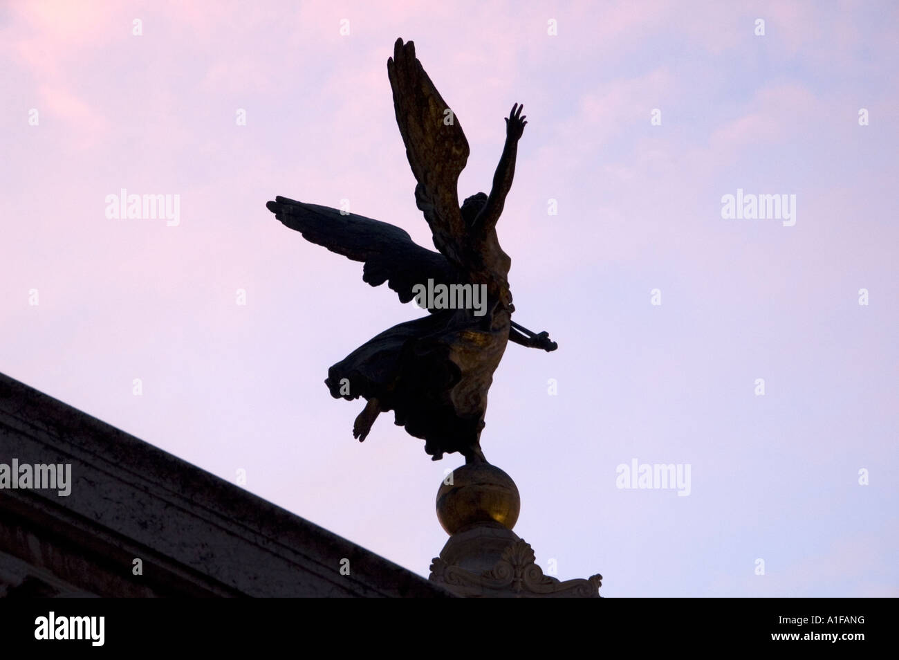 Silhouette of a winged angel statue on rooftop of Palazzo Senatorio Tabularium, Capitoline Museum in Piazza del Campidoglio, Rome Italy Stock Photo