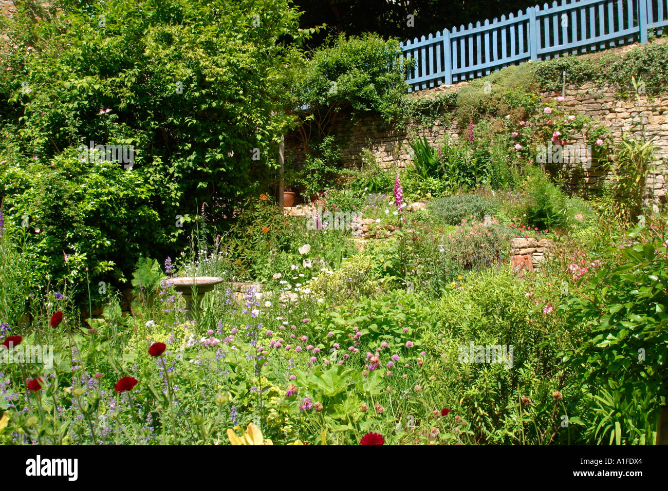 Hillside summer cottage style garden border. Stock Photo