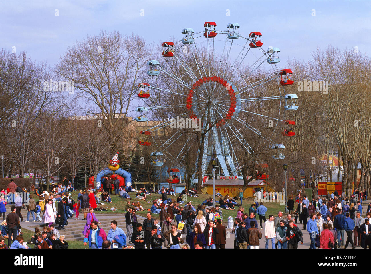 Crowds at a funfair with a big wheel during Earth Day Festival in Gorky Park in Moscow Russia G Hellier Stock Photo