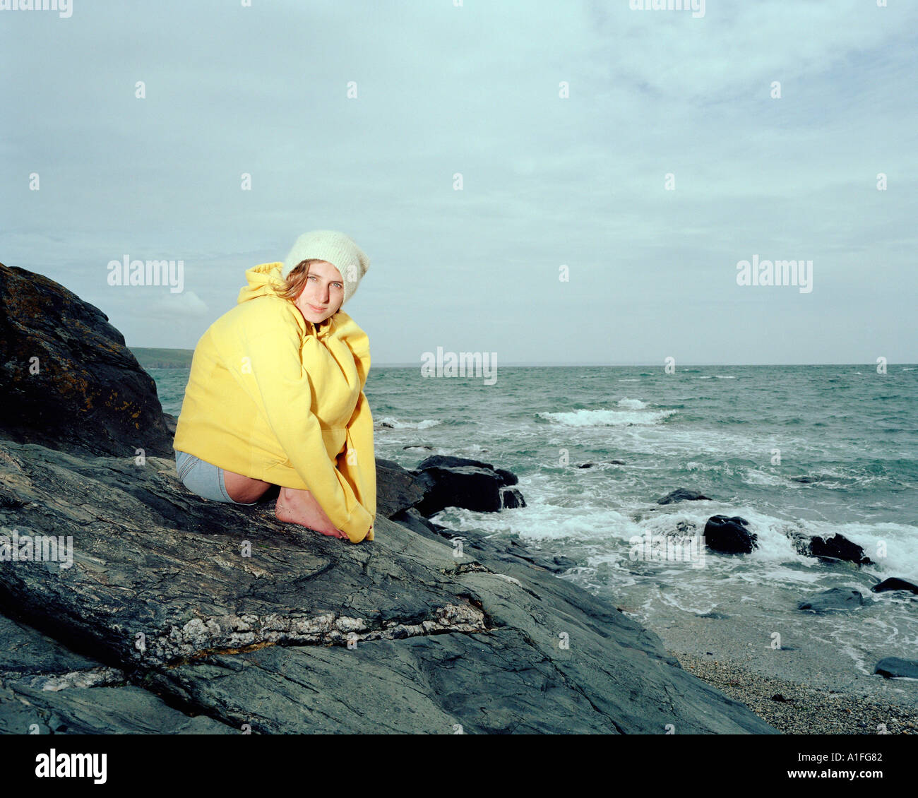 Keeping warm on the beach Stock Photo Alamy