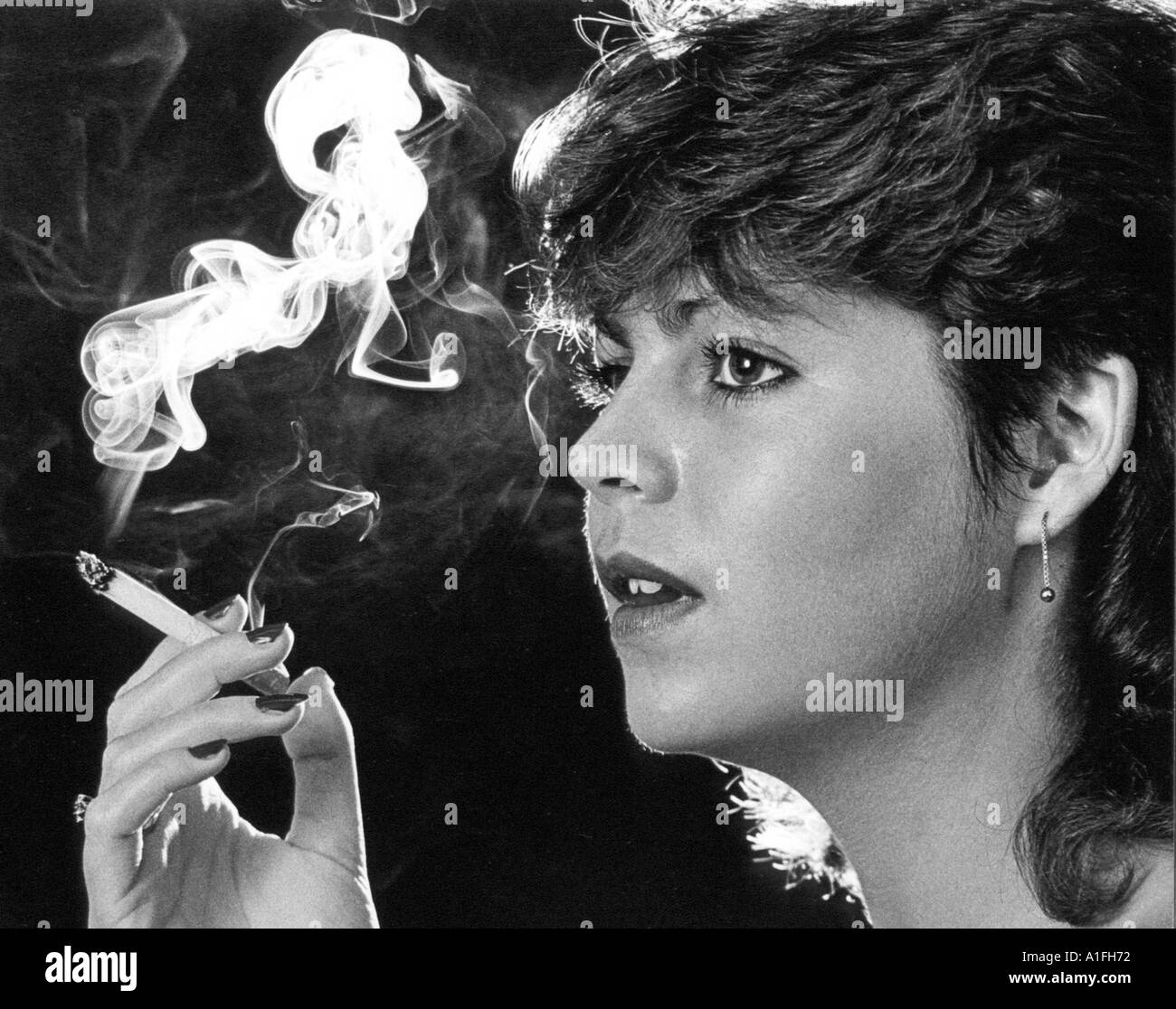 Young girl smoking cigarette Stock Photo