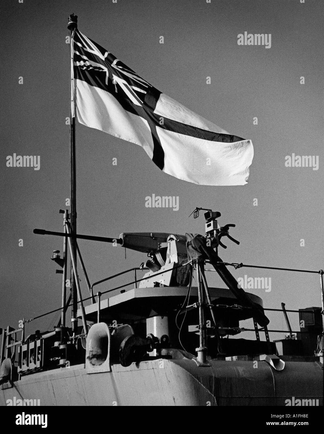 White ensign and 30mm heavy cannon on stern of British Frigate in mid 1980 s Stock Photo