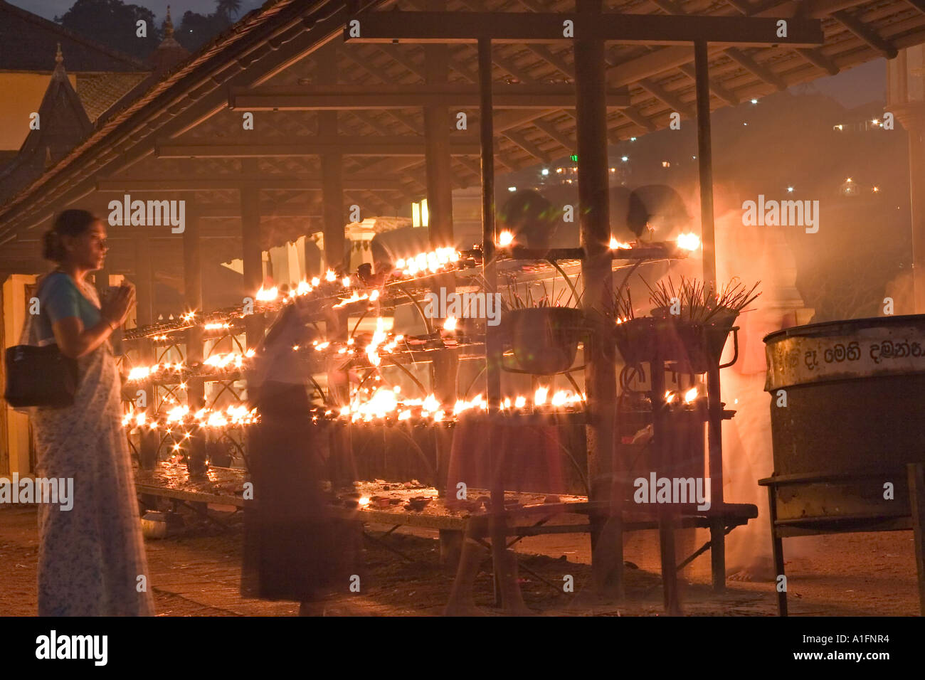 Lighting candles during Puja. Temple of the tooth, Kandy, Sri Lanka