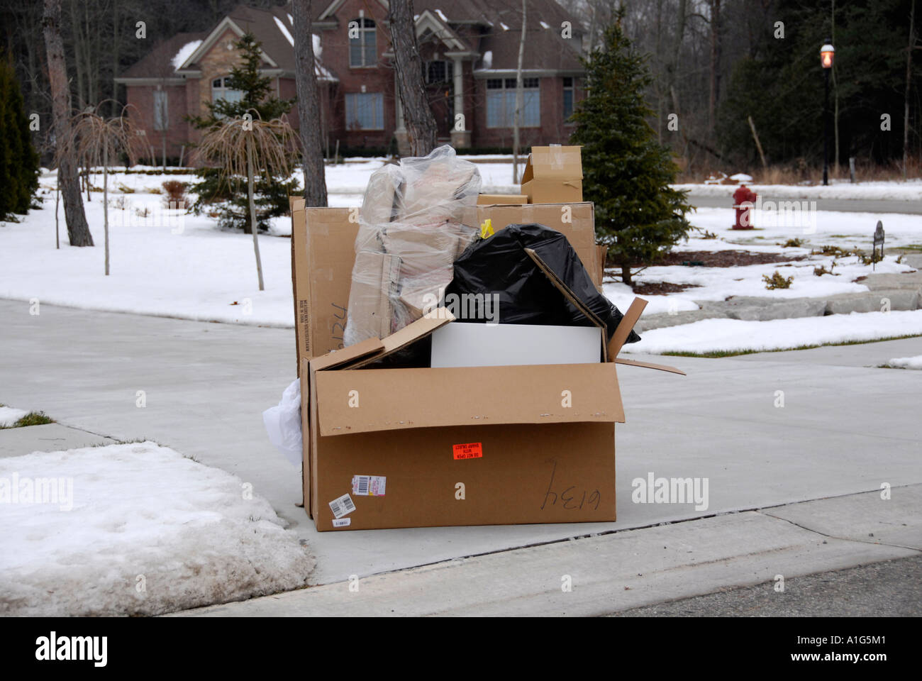 Weekly trash sit on the curb of a residential home waiting to be picked