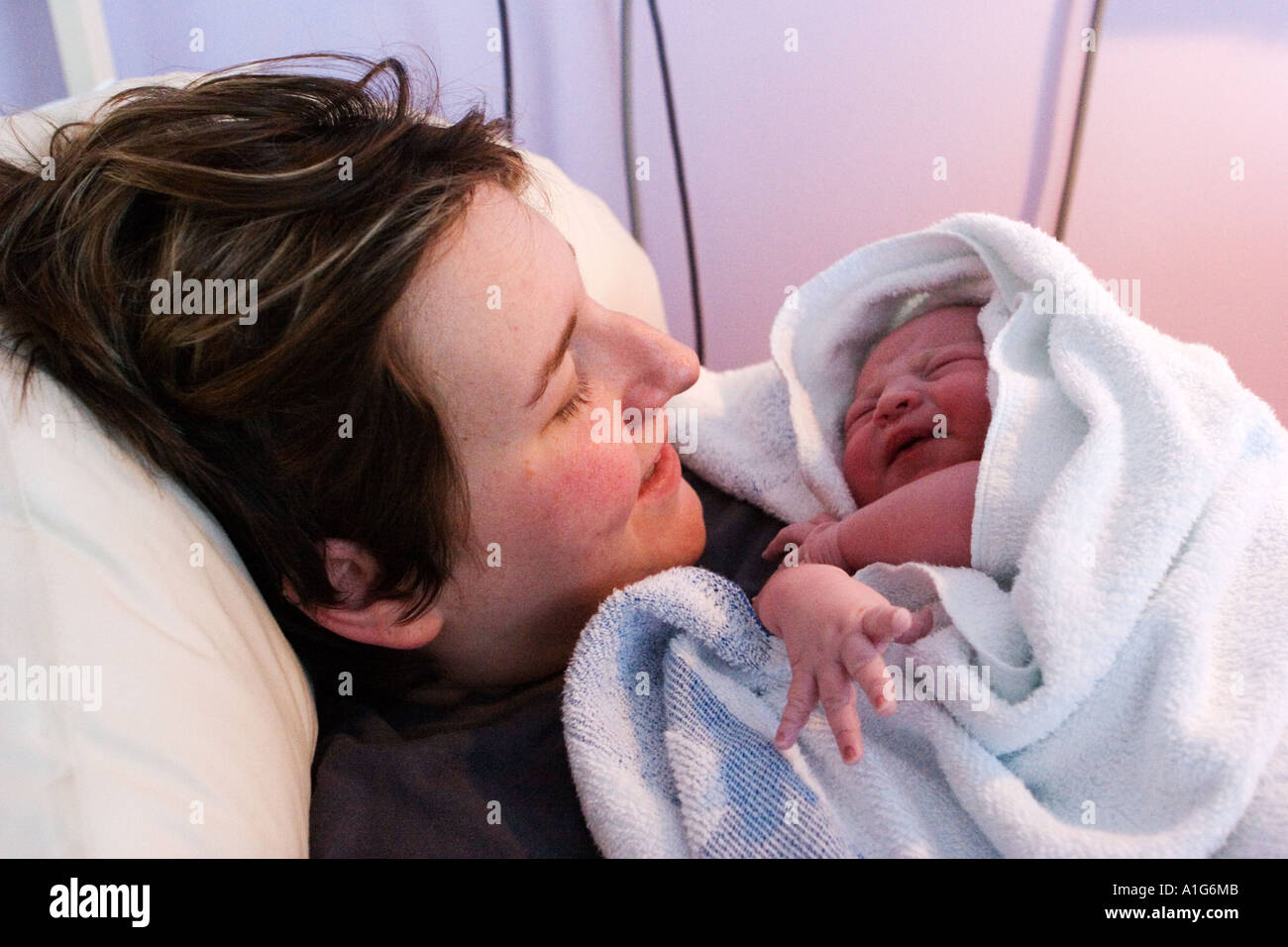 newborn baby being held by mother Stock Photo Alamy