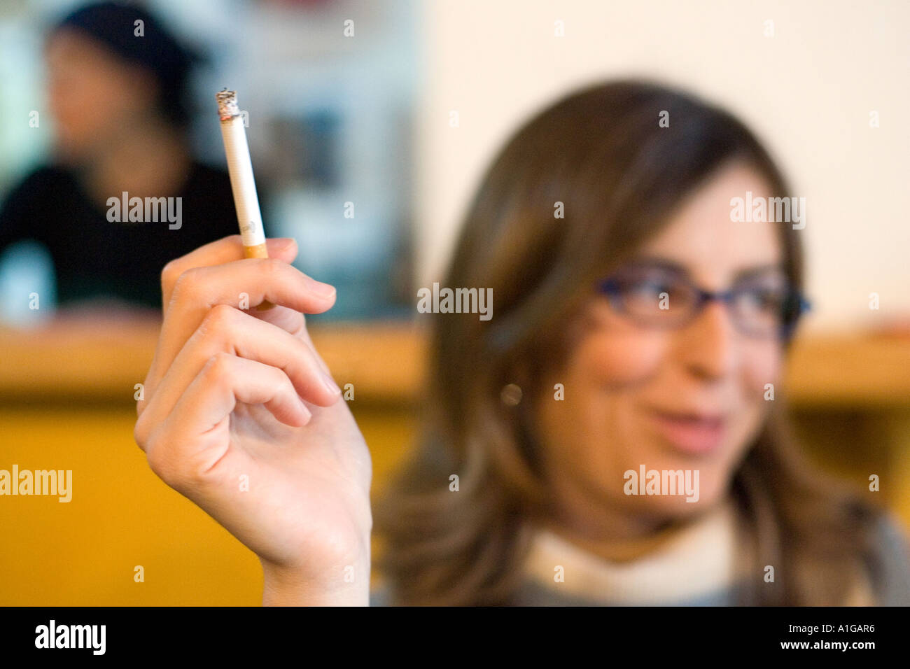 Young woman wearing glasses smoking in a bar, Spain Stock Photo Alamy