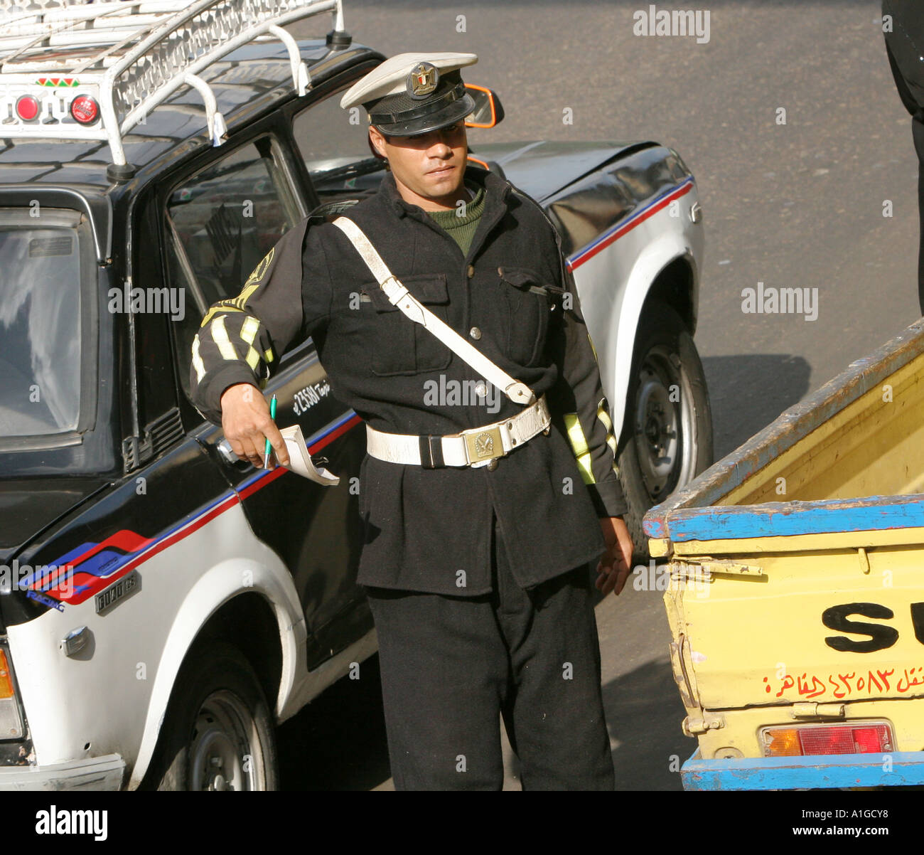 A policeman attempts to keep traffic flowing in central Cairo, Egypt Stock Photo