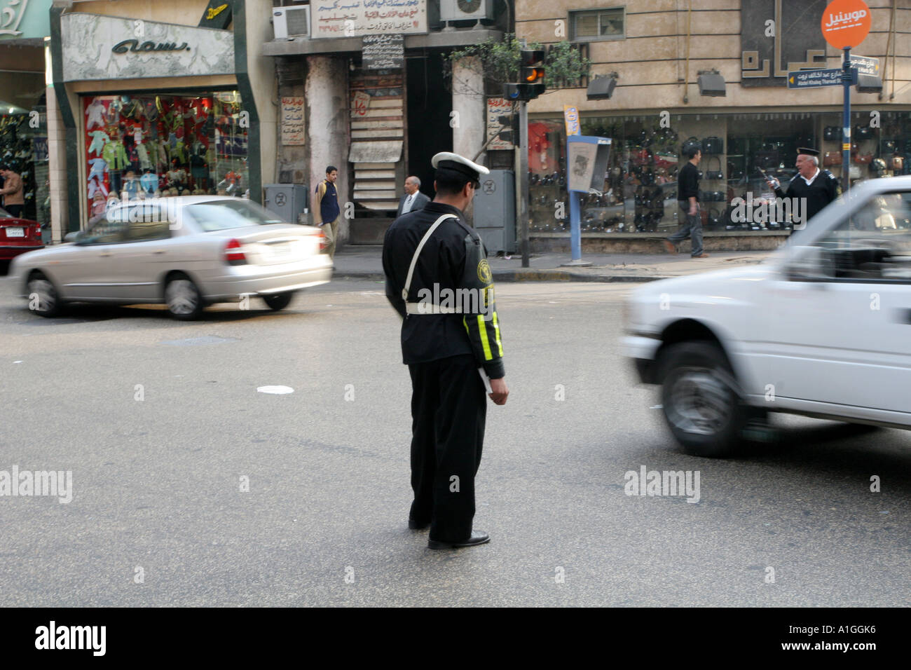 A Traffic warden directs traffic in Cairo’s downtown district. Stock Photo