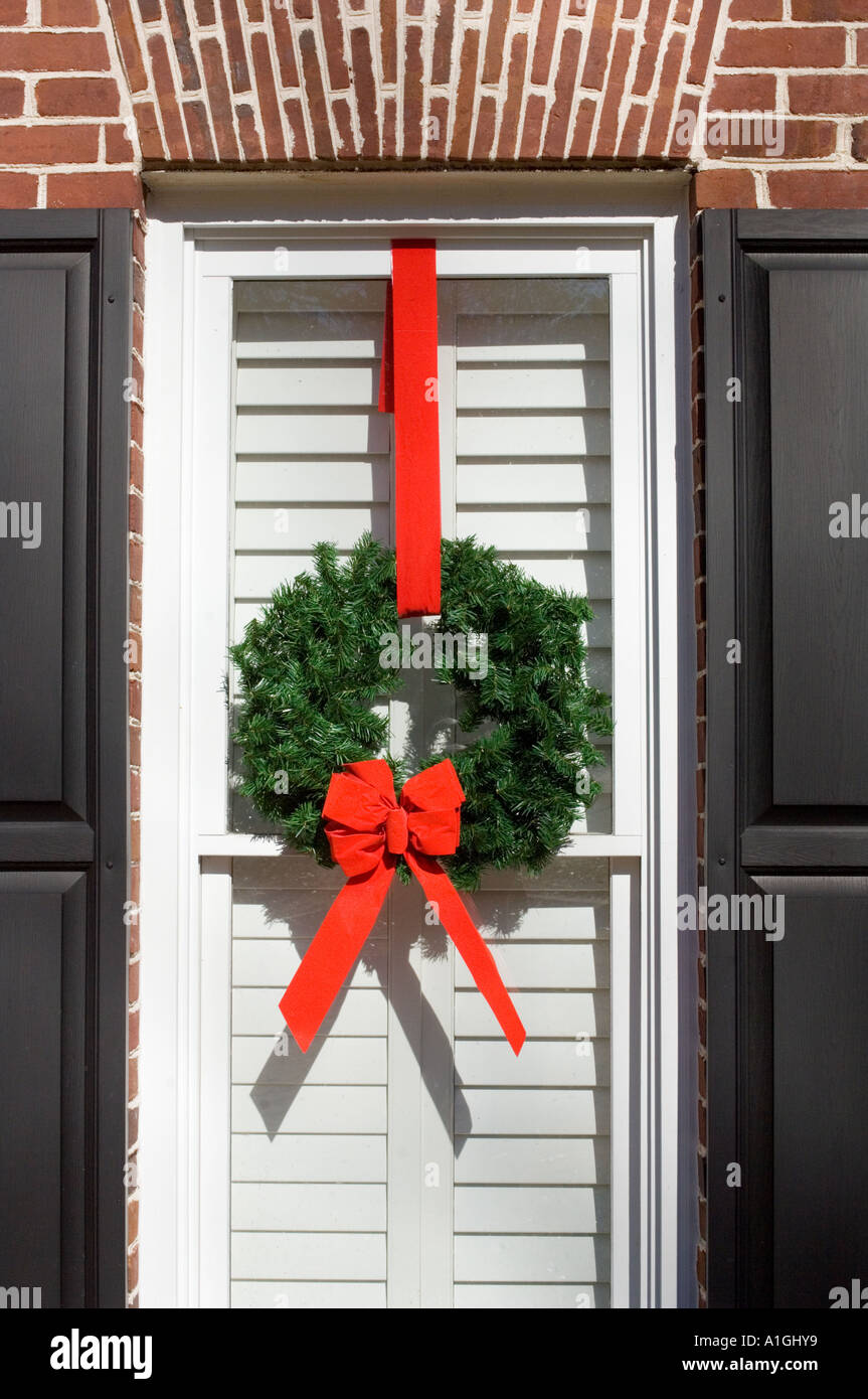 Christmas wreaths hung on widow of home Stock Photo