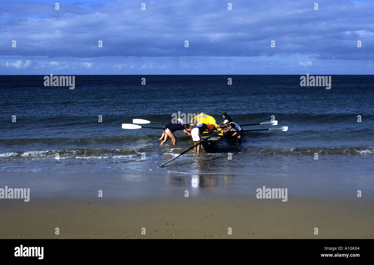 Men launching surf boat, West Beach, Burnie, Tasmania, Australia Stock Photo