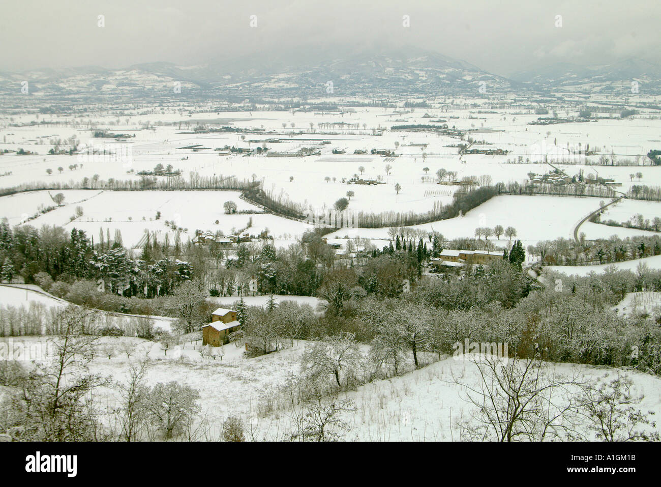 The Upper Tiber Valley after snowfall border of Tuscany and Umbria with the Appenines behind Italy Stock Photo