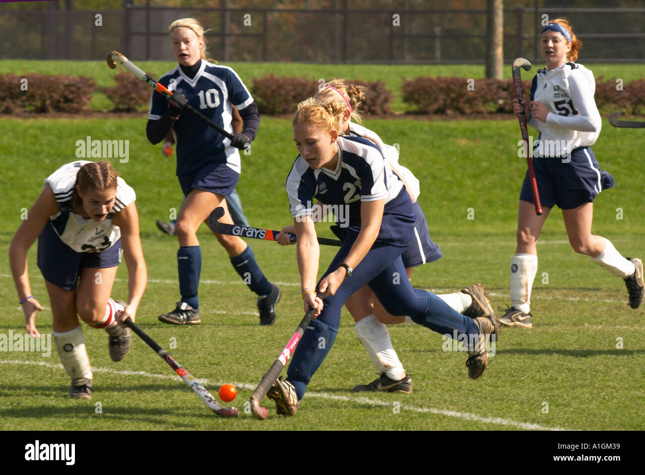 Girls Field Hockey charging down field offense and defense Stock Photo