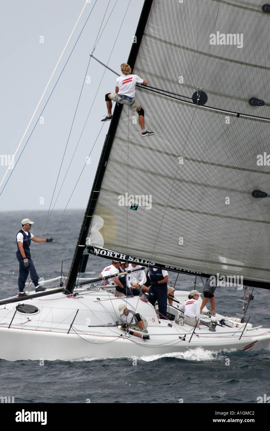 Man aloft in modern yacht race Stock Photo