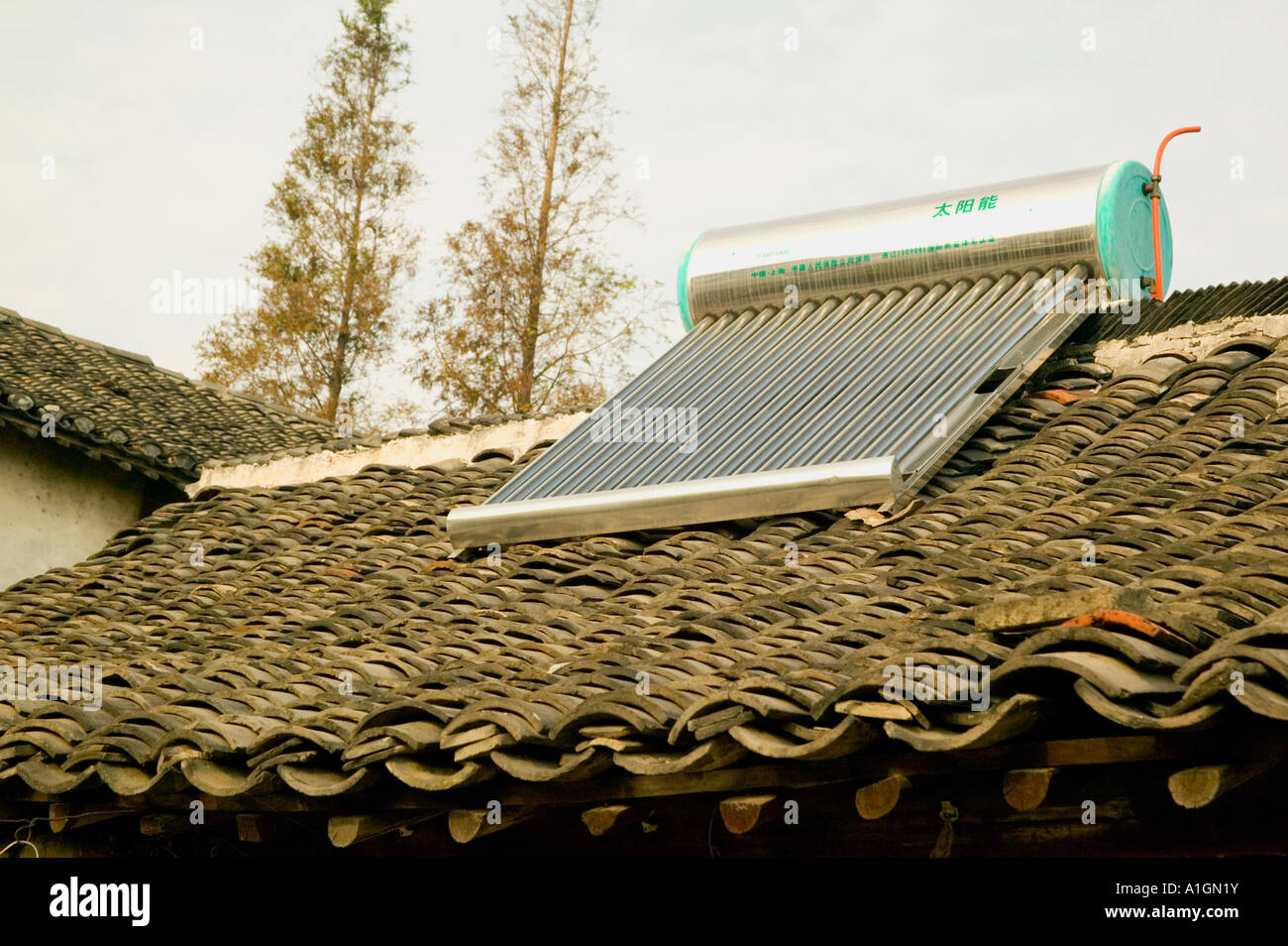 Solar water heater on tiled roof, Xitang, Ancient Water Village, China Stock Photo