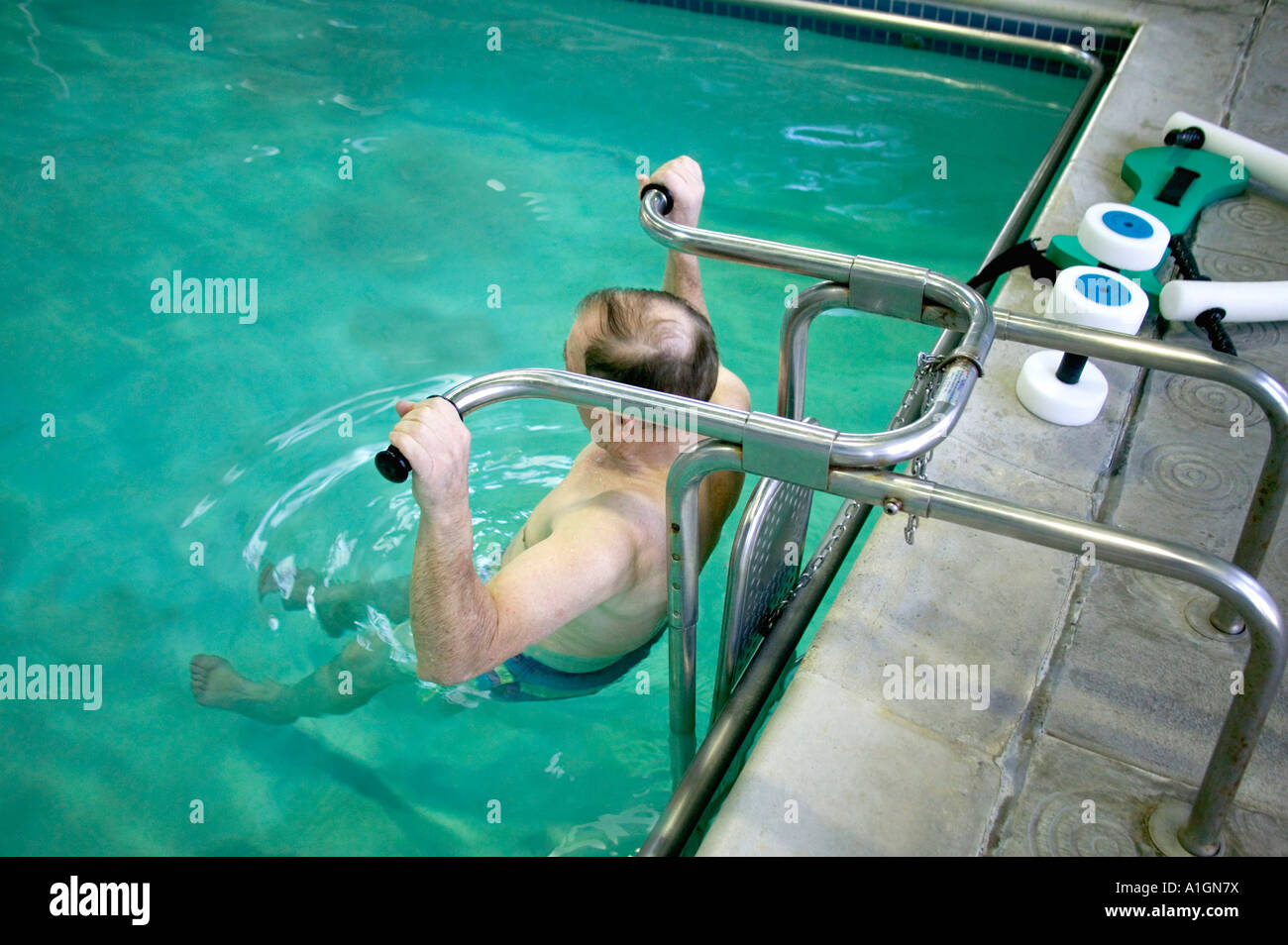 Senior male exercising, therapy pool Stock Photo