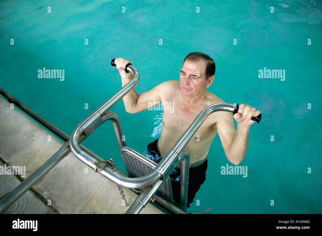 Senior male exercising in therapy pool, Stock Photo