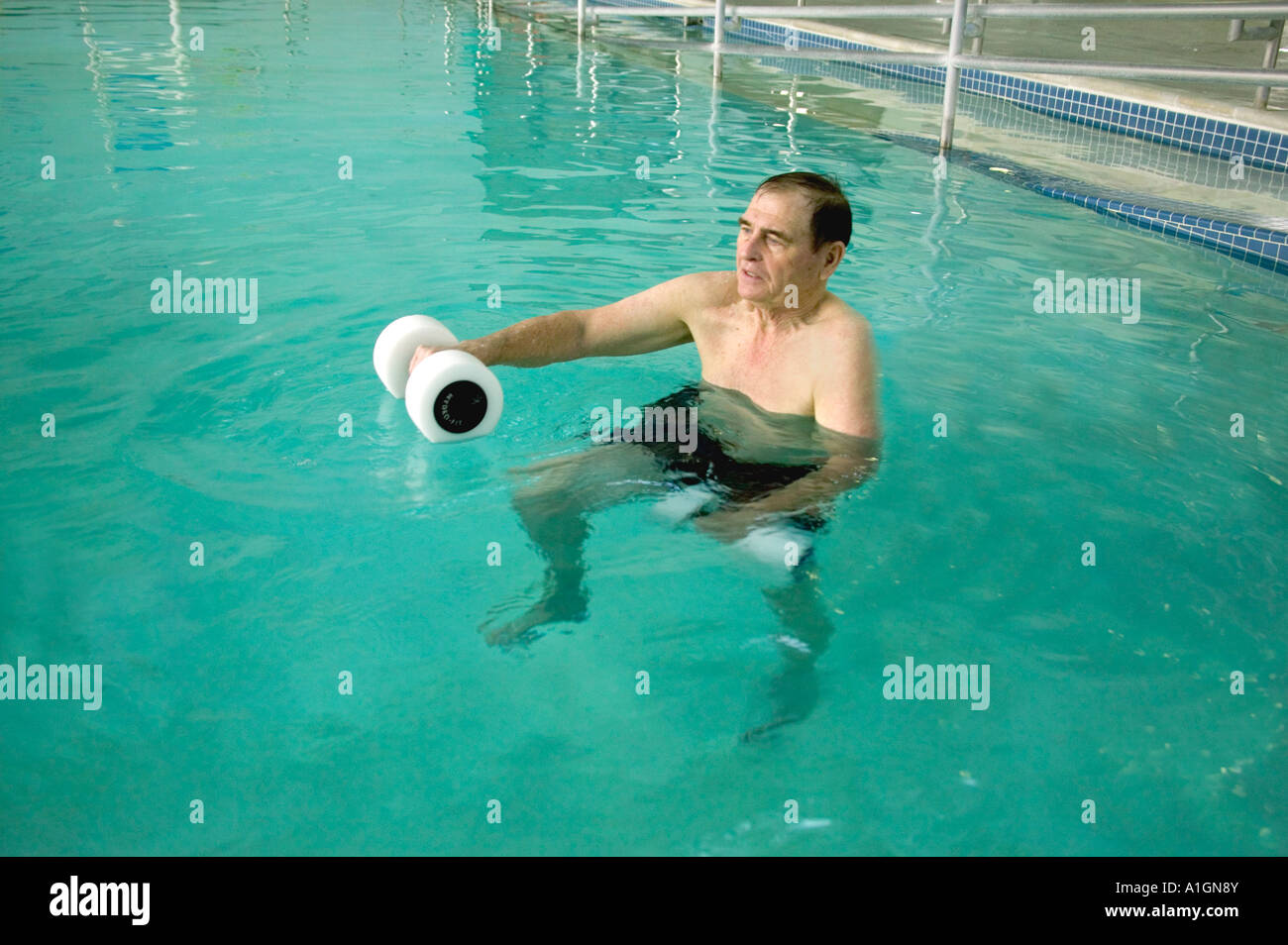 Senior male patient exercising, therapy pool Stock Photo