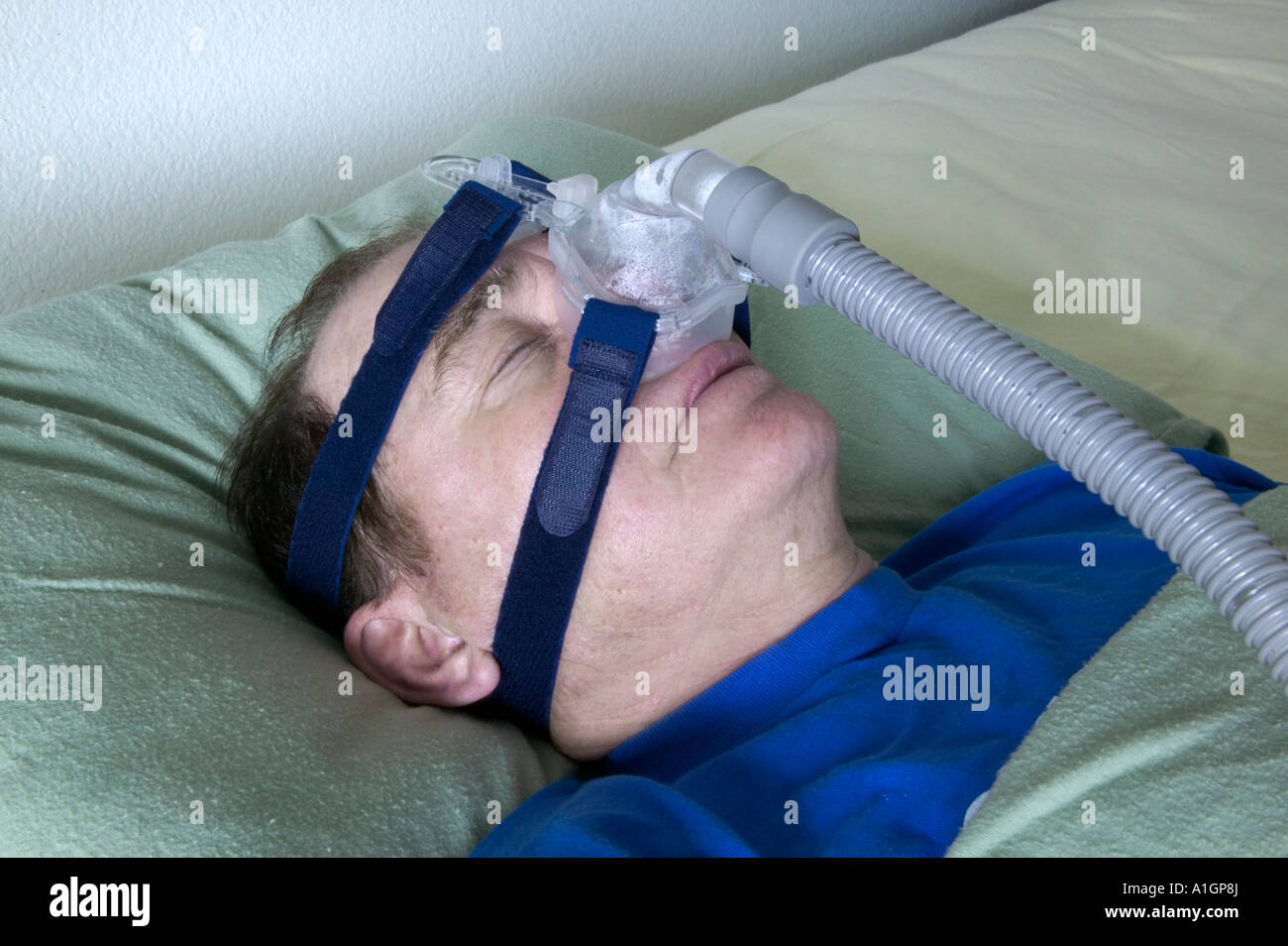 Senior male sleeping using assisted breathing device, Nevada Stock Photo