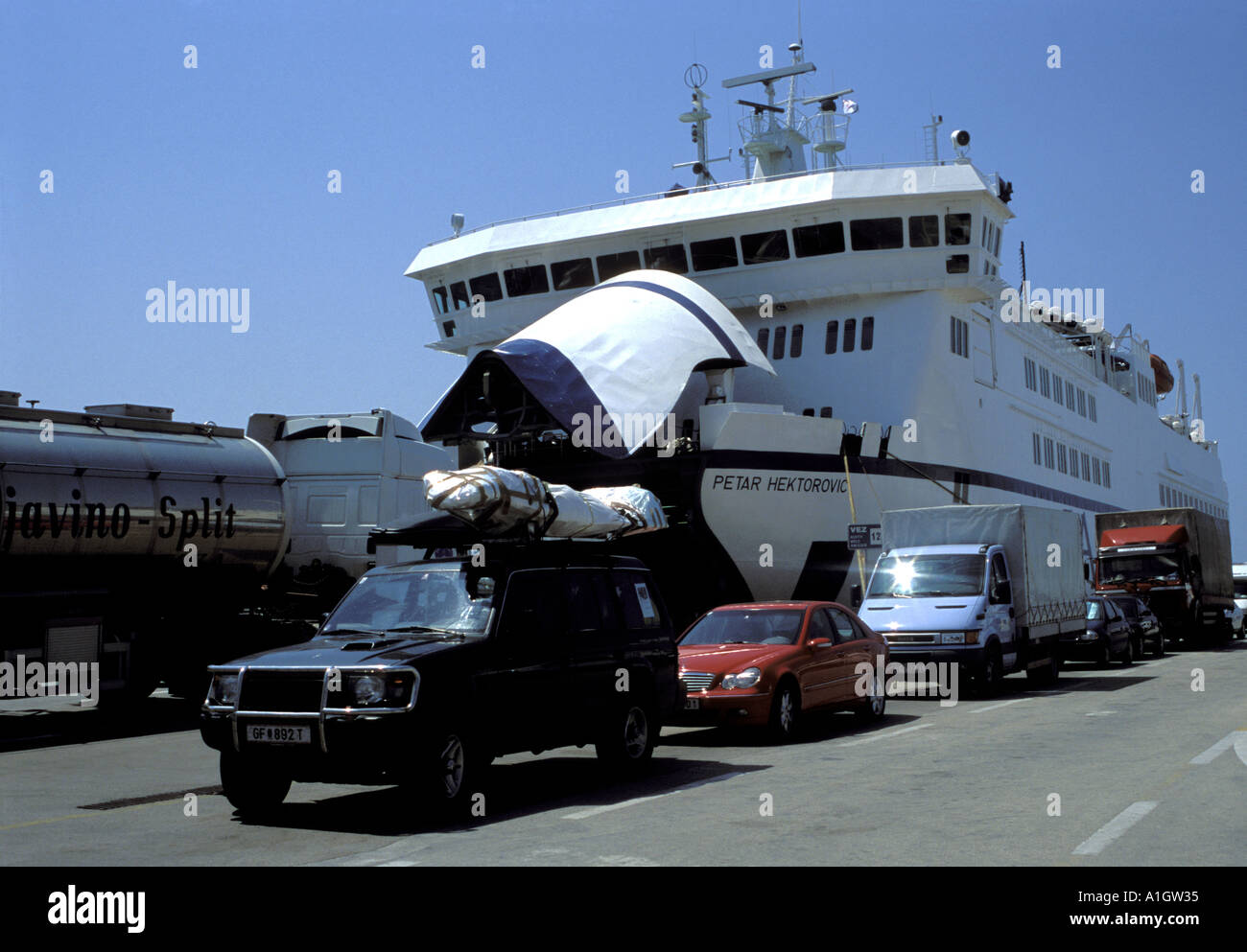 Cars and vans queueing to board Car Ferry Liner Jadrolinija docked at Split Harbour Croatia Dalmatia Makarska Adriatic May 2004 Stock Photo