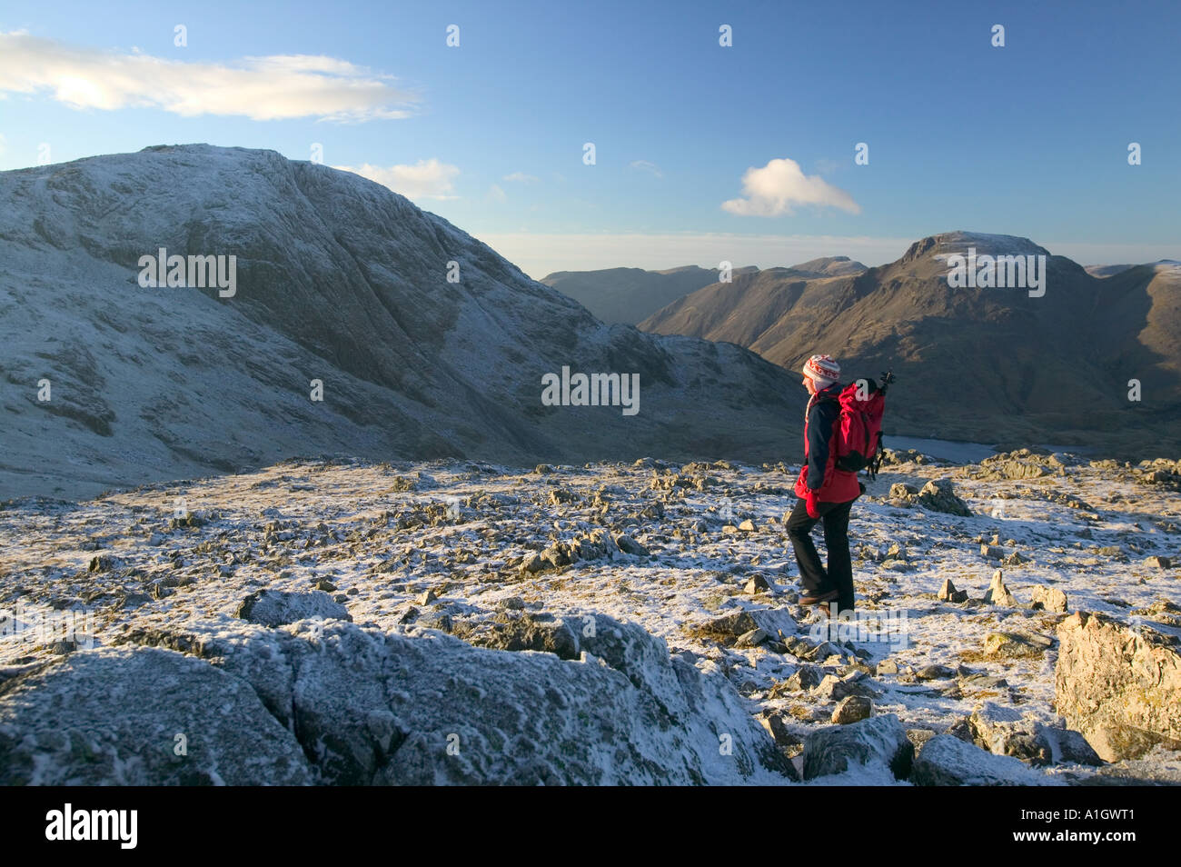 female fell walker on Glaramara with Great Gable behind, Lake district