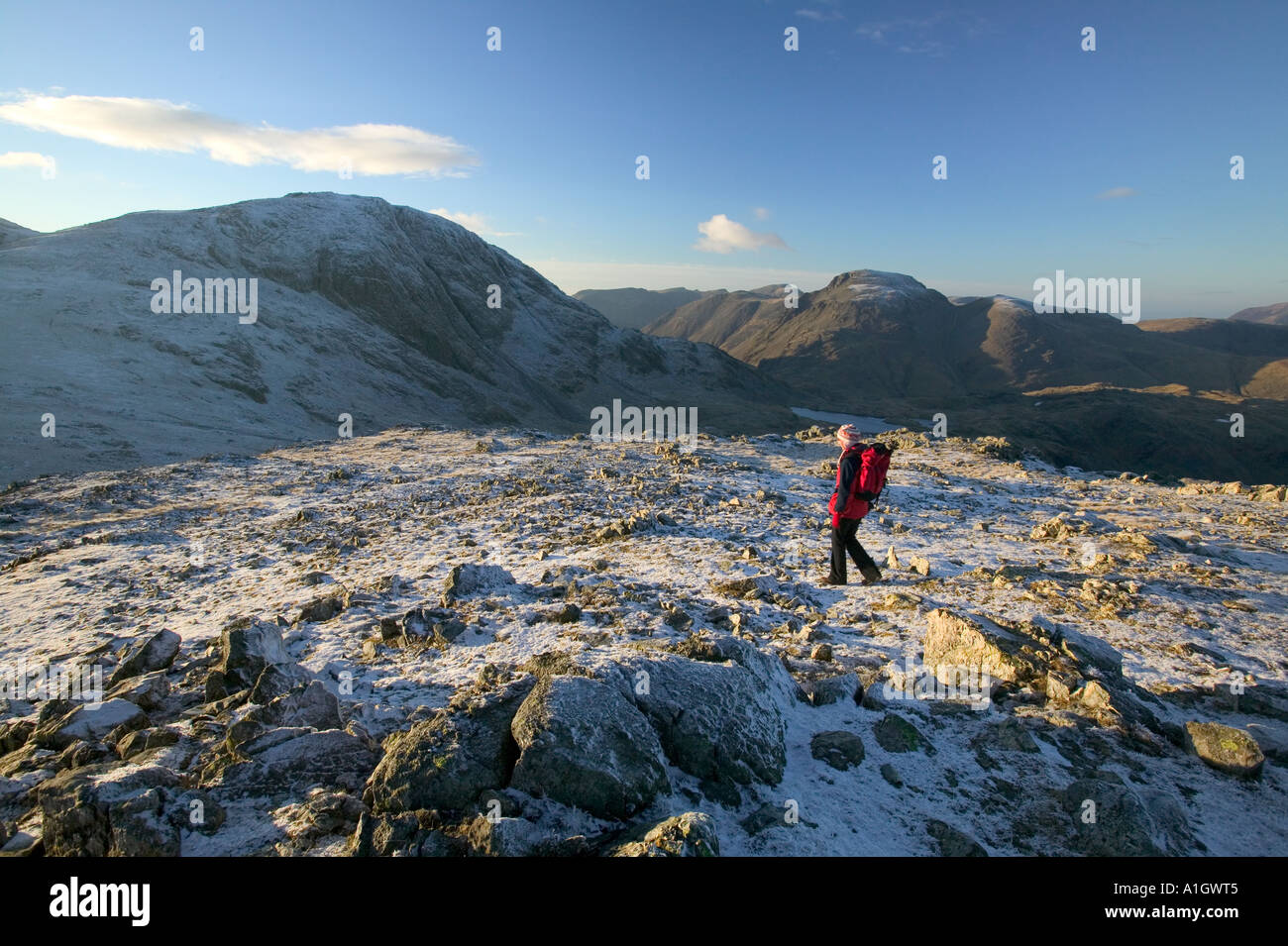 female fell walker on Glaramara with Great Gable behind, Lake district