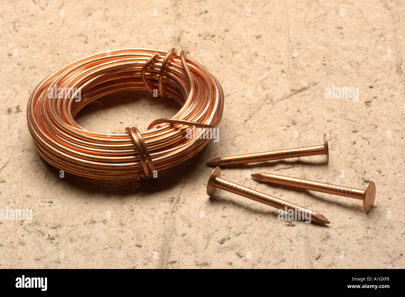Copper wire coil and nails Stock Photo Alamy