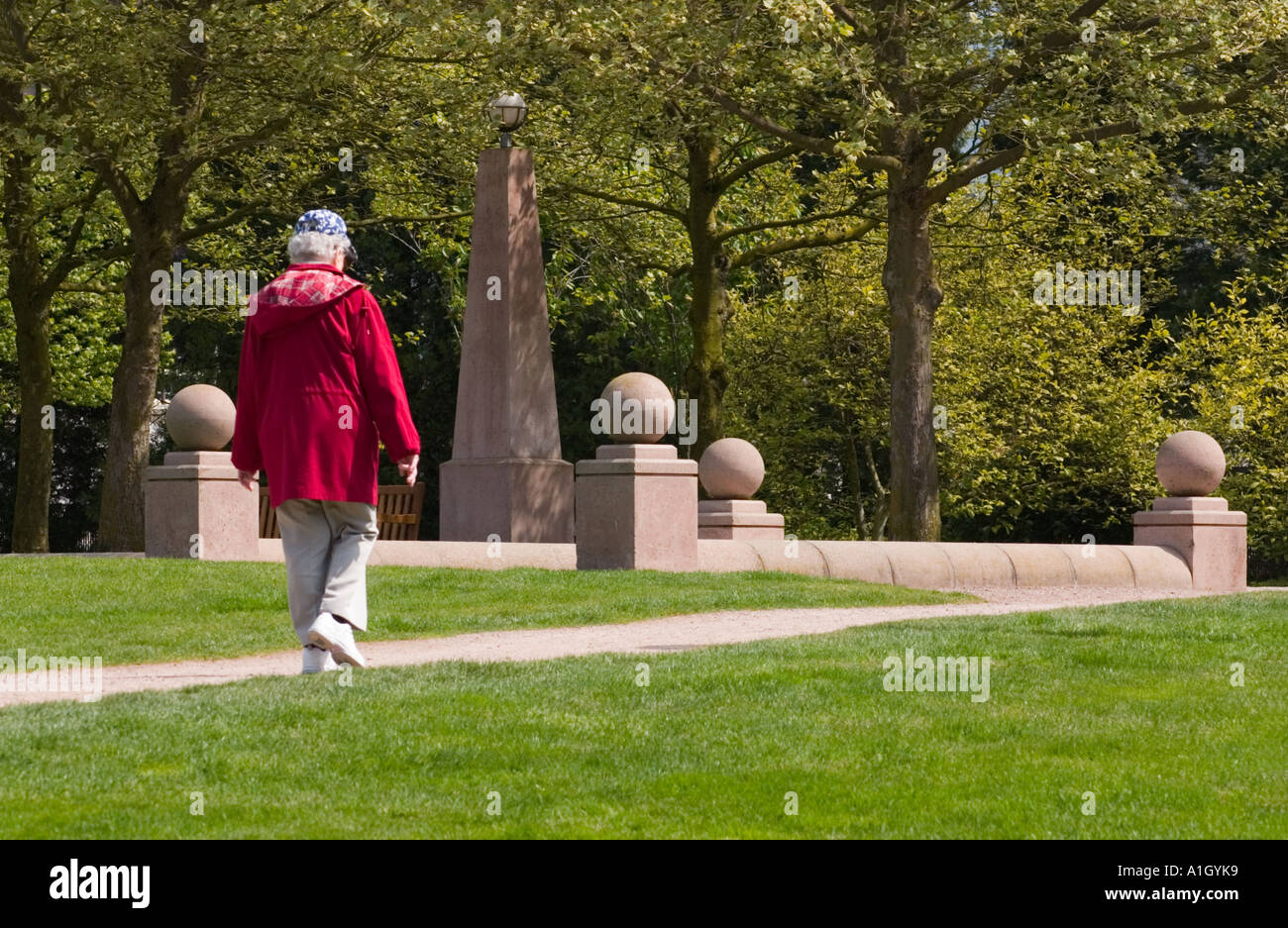 Senior woman walking in park hi-res stock photography and images - Alamy