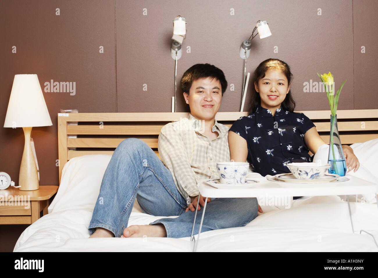 Portrait of a young man and a mid adult woman on the bed Stock Photo ...