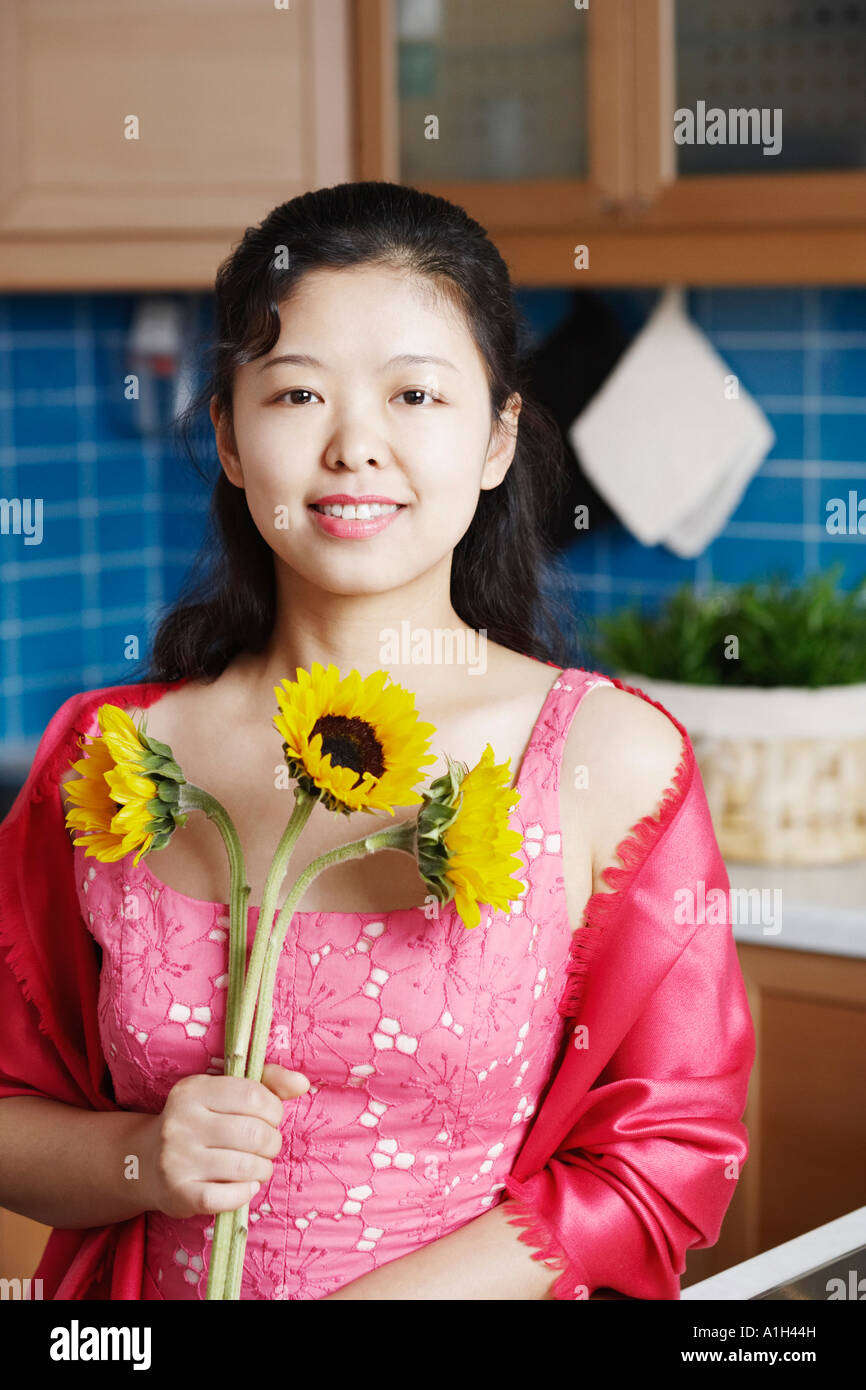 Portrait of a young woman holding sunflowers smiling Stock Photo - Alamy